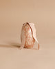 The Maileg Easter Egg, Small - Powder features a floral pattern and a beige ribbon bow, set against a matching background—an ideal decorative accent for Easter celebrations.