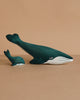 The Bumbu Handmade Wooden Blue Whale Family Set features two sustainably crafted, dark teal wooden whales—one large and one small—with white underbellies, placed side by side for inviting Montessori play.