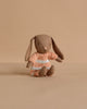 The Maileg Bunny, Micro - Brown wears a dusty rose knitted suit and sits upright, making it a charming addition to your miniature dollhouse or perfect for pairing with Maileg accessories.