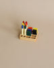 A Crayon Tray For Stockmar - 8 x 8 Slots featuring six colorful ink pads and five Stockmar sticks neatly arranged on a beige background.