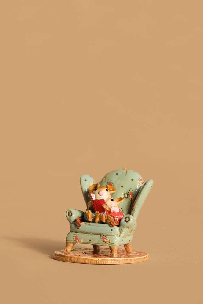 The Wee Forest Folk Tiny Collectible - Sharing A Story features a hand-sculpted mouse reading with a teddy bear in a green armchair, set against a plain beige background.