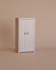 The Maileg Nursery Set with Brothers and Sisters features a small white two-door cabinet, perfect for storing tiny treasures or accessories for Maileg mice and their matchbox beds, displayed against a plain beige background.