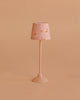 The Maileg Floor Lamp, Miniature - Dark Powder features a small pink stand and floral-patterned lampshade, making it perfect for dollhouse decor. Displayed against a simple beige background.