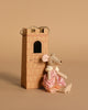 A small Maileg Queen Mouse in a pink dress and crown sits beside the Maileg Royal Tower Set, which features a handle and the phrase "let the story begin," all placed against a beige background.
