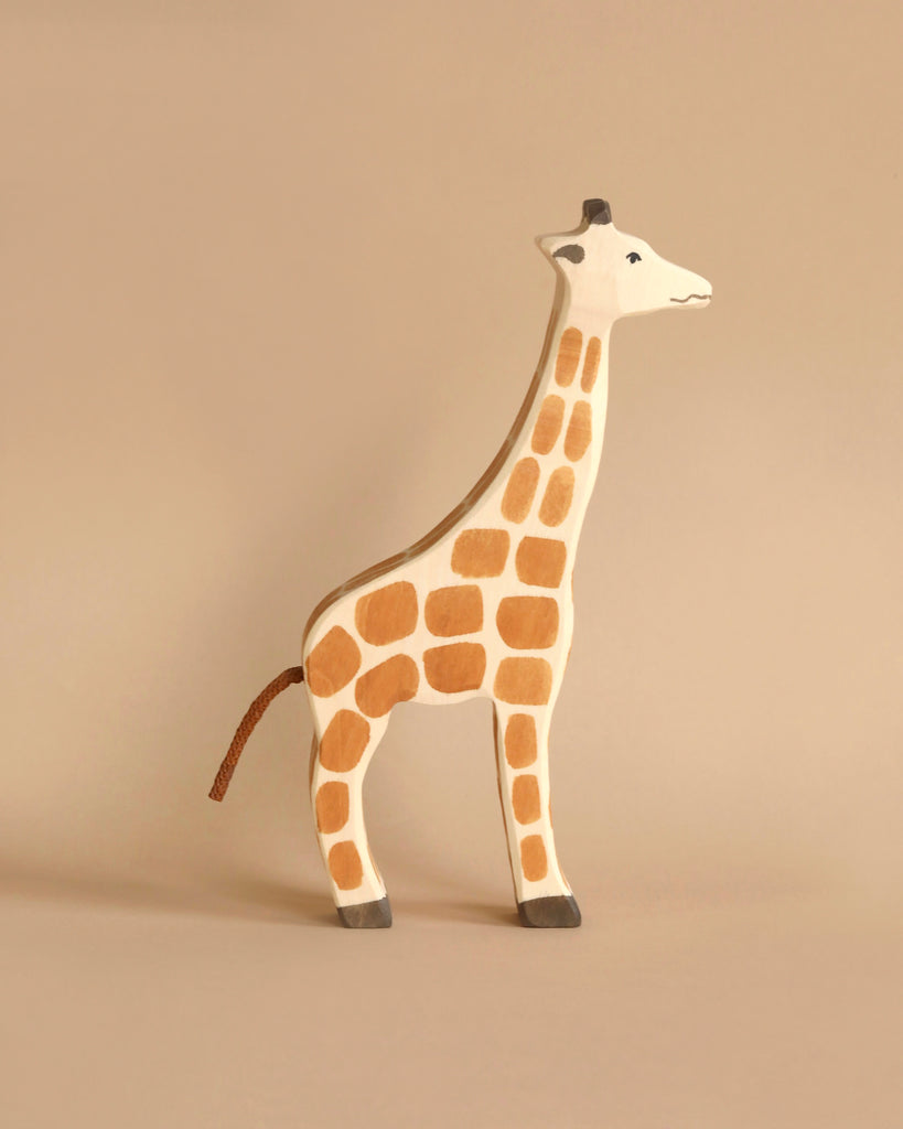 Holztiger Handmade Wooden Safari Animals Set giraffe toy with a painted brown spot pattern and a rope tail.