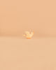 A small, white Ostheimer Bird - Flying Dove figurine with an orange beak stands on a pale beige surface against a matching plain background, reminiscent of the charming handcrafted quality and non-toxic materials for which Ostheimer wooden toys are beloved.