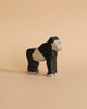 Part of the Holztiger Handmade Wooden Safari Animals Set, this hand-painted wooden gorilla in black and light beige stands on a beige surface—ideal for imaginative play.