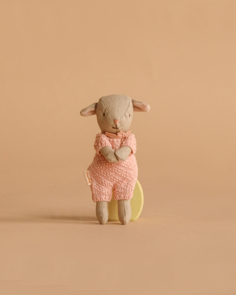 A Maileg Easter Egg with Lamb & Extra Clothing features a micro lamb stuffed animal dressed in textured pink attire, sitting upright against a plain beige background.