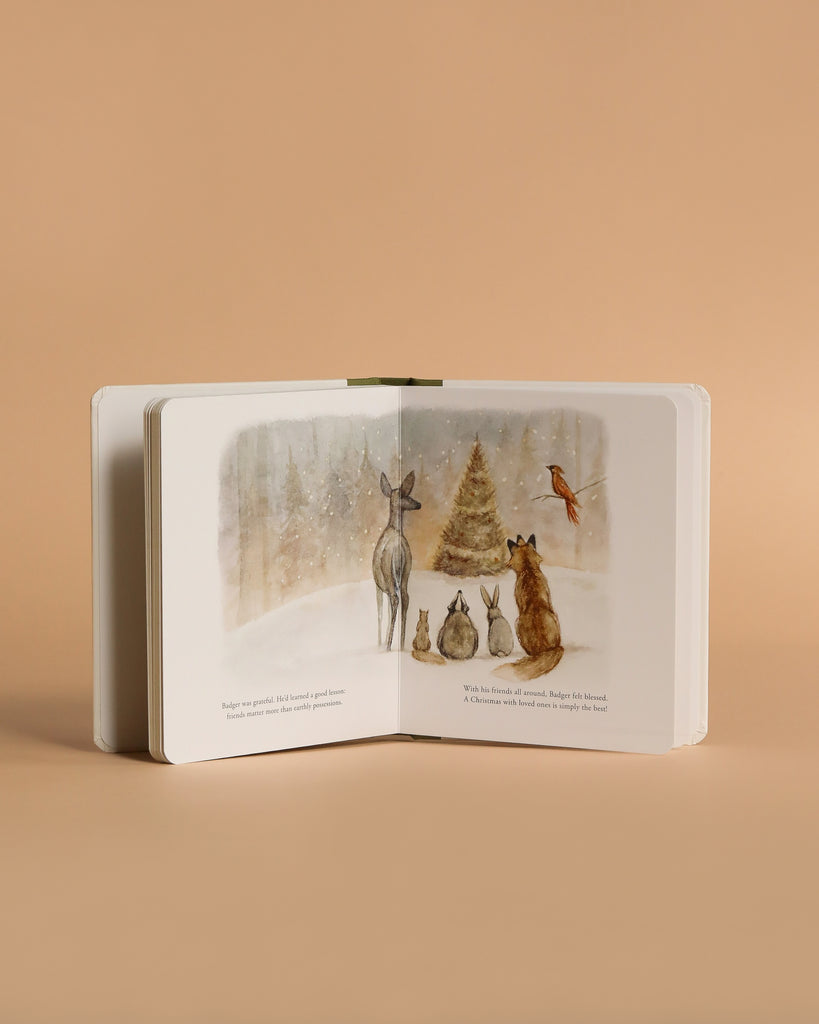 Our Little Adventure at Christmas is an open children’s board book showing a deer, two rabbits, a fox, and a robin by a snowy tree—an ideal toddler Christmas gift with a soft beige background.