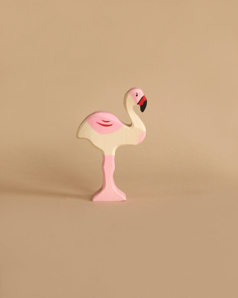Handmade wooden flamingo figurine from the Holztiger Handmade Wooden Birds of the World Set, featuring painted pink and black details.