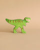 Holztiger Handmade Wooden Dinosaur Set green toy with red stripes and an open mouth.