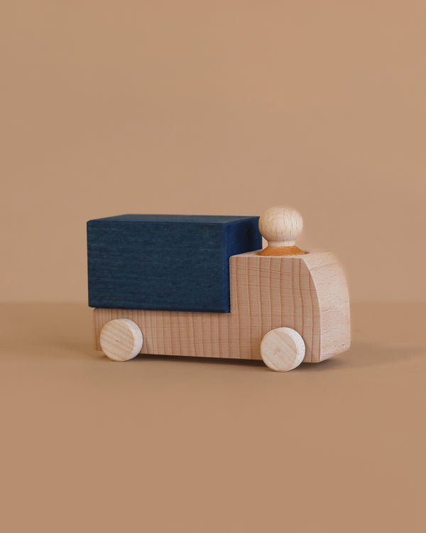 The Lubulona Wooden Truck - Blue features natural wood wheels and a blue rectangular cargo area, making it an ideal eco-friendly toy for kids and collectors alike.