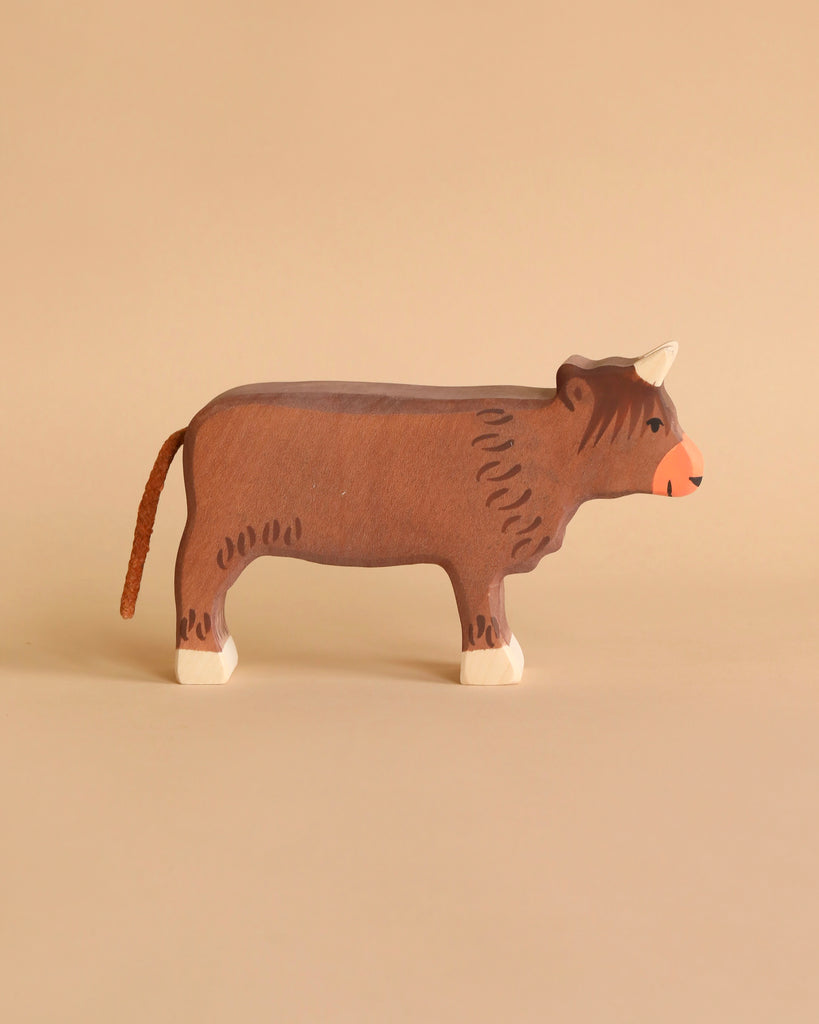 Holztiger Handmade Wooden Highland Cow Family Set figure featuring a brown Highland cow with a textured tail, perfect for open-ended play.