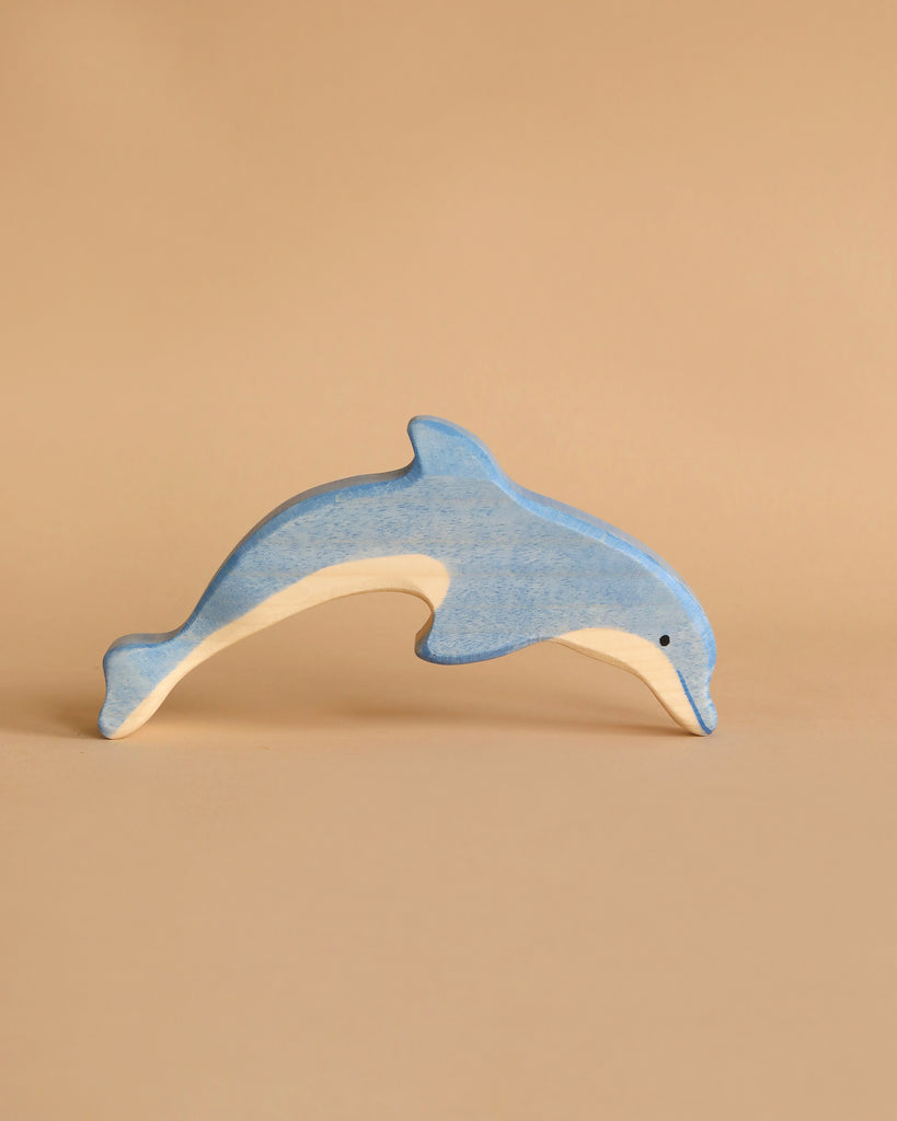 A Holztiger Handmade Wooden Ocean Animals Set handcrafted wooden toy dolphin painted blue and natural wood.