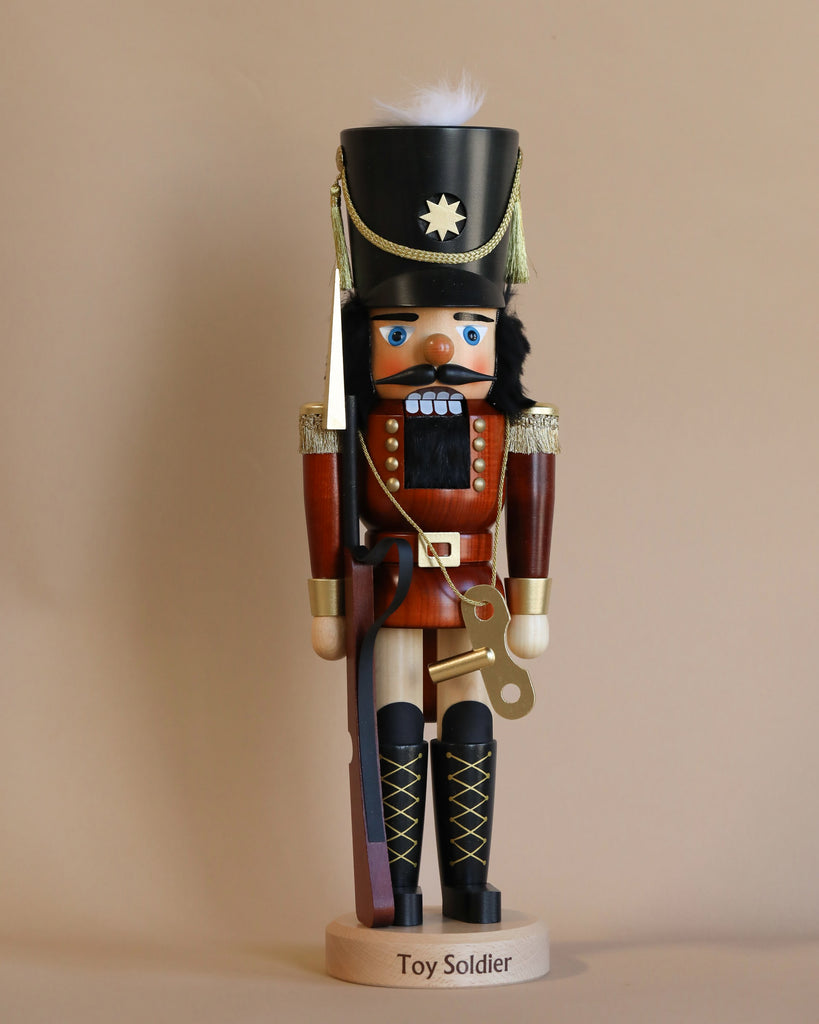 Introducing the Christian Ulbricht Nutcracker - Toy Soldier Limited Edition 5000, a traditional wooden nutcracker crafted as a toy soldier. This collectible piece features a bushy mustache and dons a classic red and black uniform, complete with a tall hat adorned with a star and feather. It stands upright on an elegant base labeled "Toy Soldier.