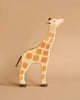 Part of the Holztiger Handmade Wooden Safari Animals Set, this upright giraffe features painted spots, brown details on its tail, feet, and ears, and is crafted from maple and beech wood.