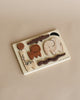 A Wooden Tray Puzzle - Safari Animals on a beige surface featuring various animal shapes like a whale, elephant, and others, each piece labeled with its name.