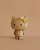 The Boyhood Hello Kitty 50th Anniversary Limited Edition is a wooden collectible with a yellow bow on its left ear, simple black features, and a smooth, rounded finish—perfect for fans of unique Hello Kitty figurines.