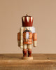 The Christian Ulbricht Collectible Wooden Nutcracker - King (Natural) stands on a rustic wooden surface against a plain beige background.