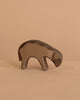 The Ostheimer Bown Sheep - Eating is a small, minimalist wooden animal sculpture, handcrafted for imaginative play, shown on a light beige surface with a matching beige background.