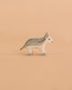 A Holztiger Handmade Wooden Woodland Animals Set figure, handcrafted from wood as a wolf with stylized grey and white painted markings, perfect for imaginative play.