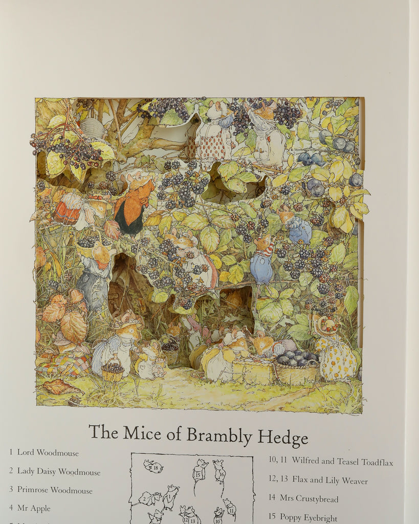 Mice illustrated in a detailed countryside scene gather among leaves and berries in The Brambly Hedge Pop-Up Book by Jill Barklem, with names like Lord Woodmouse, Lady Daisy, Primrose, Wilfred, and Teasel listed below.