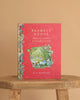 Brambly Hedge: The Classic Collection by Jill Barklem" is a red hardcover book with floral and nature illustrations on the cover, standing upright on a wooden stool against a beige background.