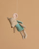 The Maileg Fairy Mouse, Little - Mint features a beige plush mouse with large pink ears, a mint outfit, and soft wings, hanging by a string against a light brown background—perfect for imaginative play.