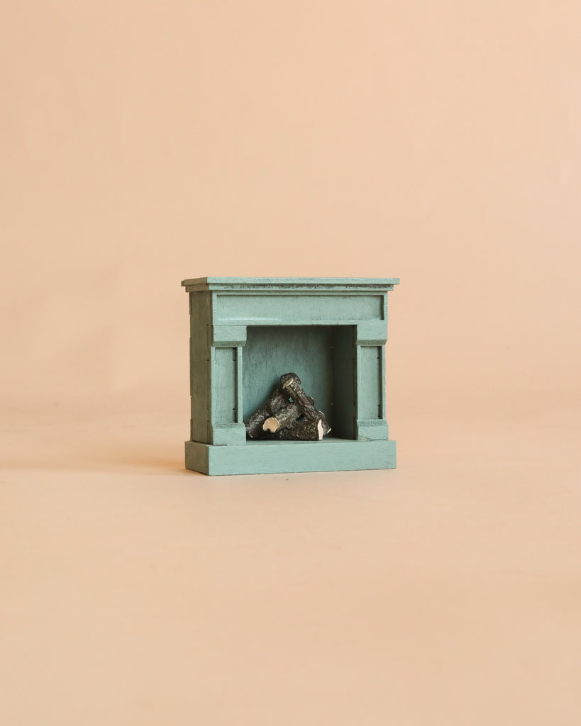A PRE-ORDER: Maileg Fireplace, Mouse - Blue (Estimated Arrival Mid August) sits on a beige background, bringing vintage charm and cozy detail to your miniature home.