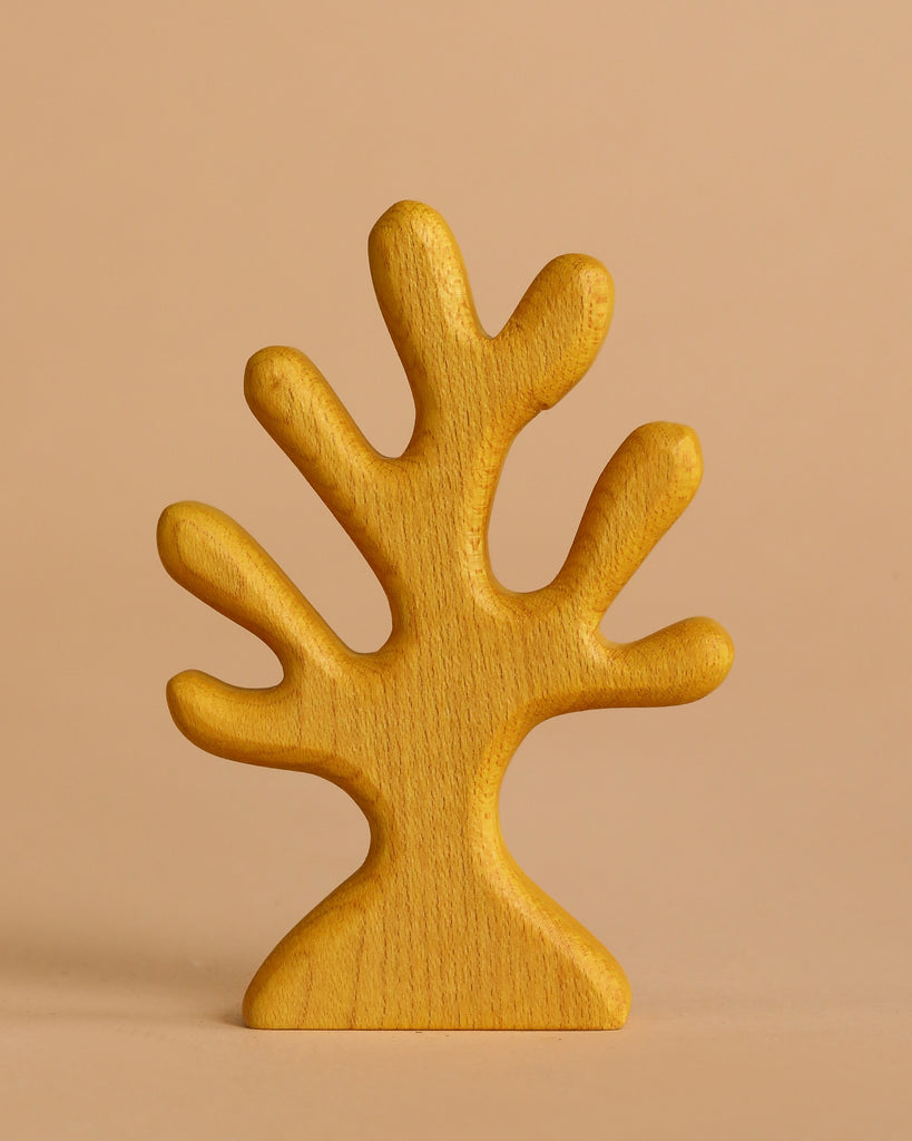 The Handmade Holzwald Yellow Coral is a simple, stylized wooden figurine with multiple rounded branches painted yellow, standing upright against a light beige background.