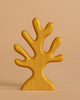 The Handmade Holzwald Underwater World Set features a warm yellow, stylized wooden sculpture with five rounded branches—ideal as an educational toy or to enrich your Holzwald toys collection.