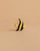 This yellow, black-striped toy fish stands upright on a beige background—a charming piece from the Handmade Holzwald Underwater World Set, perfect as an educational wooden sea animal toy.