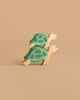 Two toys from the Handmade Holzwald Underwater World Set—wooden turtles with green shells—are stacked on each other against a beige background, showcasing the charm of handmade wooden sea creatures.