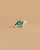 A Handmade Holzwald Sea Turtle, Small, with a green shell and beige body, is displayed on a plain light brown background, inviting open-ended play.