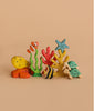 The Handmade Holzwald Seaweed is a sustainable wooden toy set featuring sea creatures such as a yellow fish, clownfish, striped fish, two turtles, a blue starfish, and vibrant coral—perfect for imaginative play.