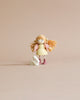 A small Amy and her Rabbit doll with blonde yarn hair, dressed in yellow and pink jersey fabrics, stands next to a tiny white rabbit figurine against a neutral background.