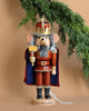 The Christian Ulbricht Collectible Wooden Nutcracker - Mouse King is a limited-edition piece crafted to resemble a regal mouse king, complete with a crown, sword, and cape. Set against a tan background with evergreen branches enhancing its festive appeal, this exquisite nutcracker is made in Germany and embodies timeless holiday tradition.