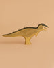 The Handmade Holzwald T-Rex Green—a handcrafted wooden dinosaur painted in green—stands upright, ideal for imaginative play and a great addition to any sustainable toy collection.