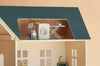 A Maileg Fully Furnished Dollhouse Set + Surprise Gift includes miniature accessories such as a washing machine, an ironing board with an iron, and a vacuum cleaner, all in a charming beige and green color scheme.