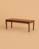 Miniature rectangular Maileg Dining Set Set table with four curved legs and a dark-edged top.