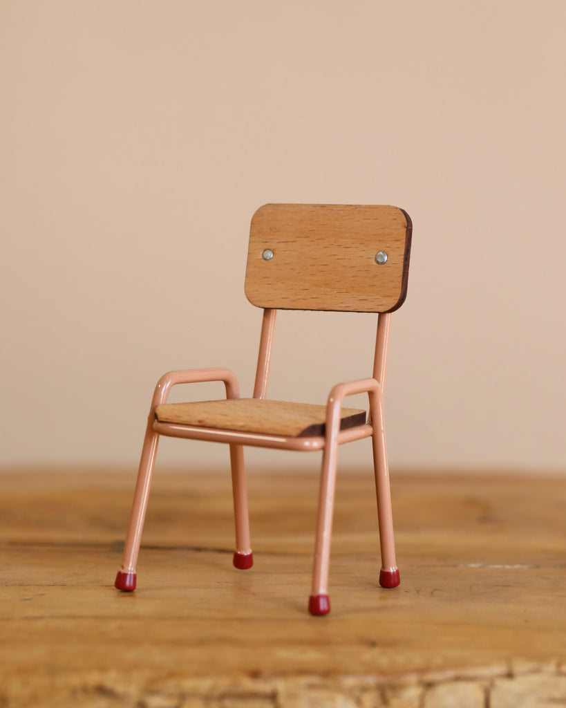 A Maileg Little Green Thumb Garden Set is displayed on a wooden surface against a plain beige background.