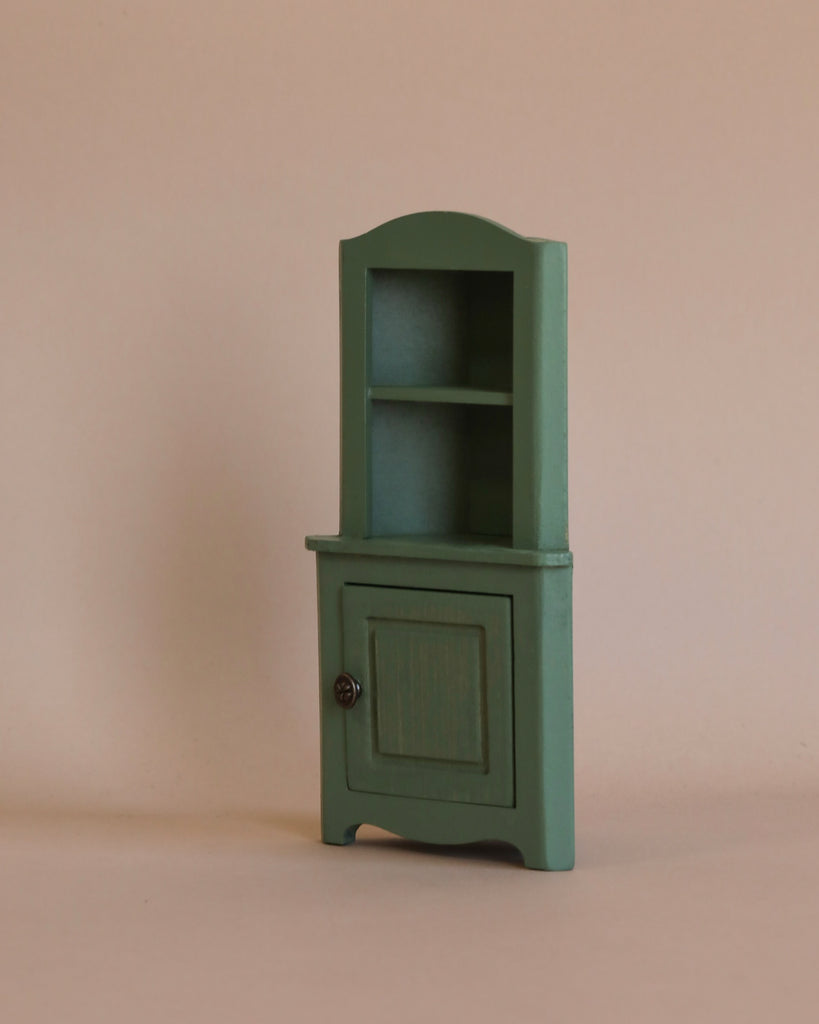 A sage green miniature corner cabinet from the Maileg Bathtub Set, featuring an open upper shelf and a cupboard below, perfectly sized for a Maileg mouse.