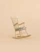 Miniature wooden rocking chair with a patterned fabric seat cushion from Maileg Grandma’s Living Room Set.