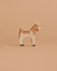 A handcrafted Holztiger Handmade Wooden Farm Animals Set goat figurine with brown and tan markings.