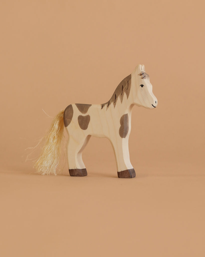 Holztiger Handmade Wooden Farm Animals Set toy horse with brown spots, a painted mane, and a fibrous tail.