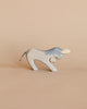 A handcrafted Ostheimer Donkey - Stubborn, painted light blue with visible wood grain, posed against a plain beige background. The donkey has small white ears and a thin tail.