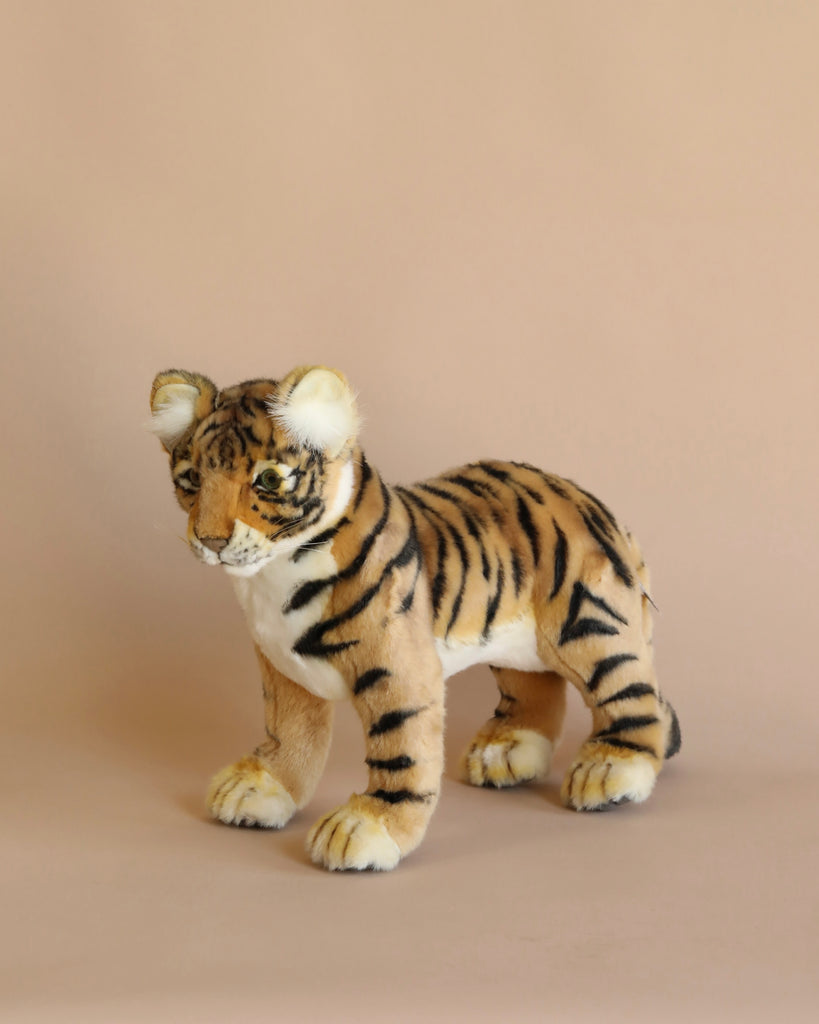 The Safari Tiger Family Set features plush tigers with lifelike orange fur, black stripes, and white accents, posed realistically on a plain beige background.