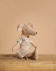 A fabric mouse doll from the Maileg Family Celebration Set sits on a wooden surface against a plain beige background, perfect for pairing with other Maileg accessories or adding to your Maileg mouse collection.