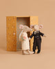 The Maileg Just Married Set features two wedding mice—a bride in a lace dress and veil, and a groom in a suit with bow tie—standing before an open floral box. Ideal for Sophie's Dolls House, with a beige background shown.