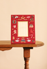 Beary Christmas Embroidered Picture Frame in red, featuring festive icons including a teddy bear, swans, gingerbread house, and holly.